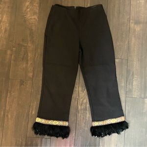 Women small cropped pants.  Beautiful detail on bottom of pants with feathers.